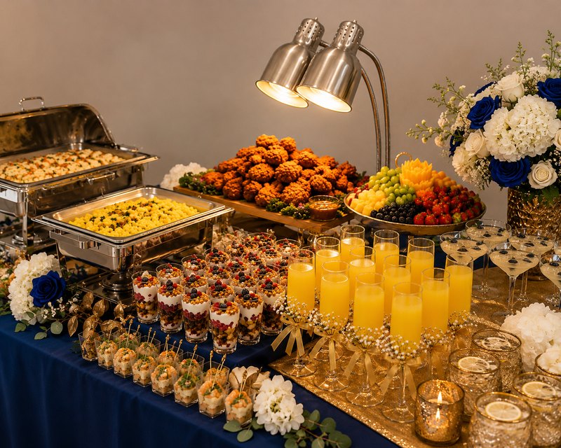 Brunch buffet with chafing dishes, fruit and mimosas