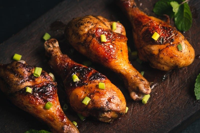 Island fire jerk chicken drumsticks glazed and garnished